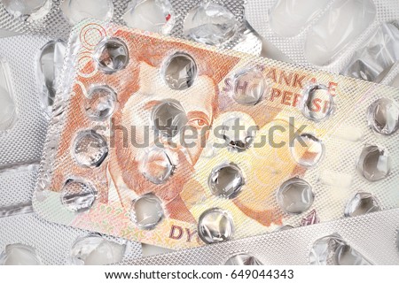 Banknote 200 Albanian leks on an empty blister pack of tablets