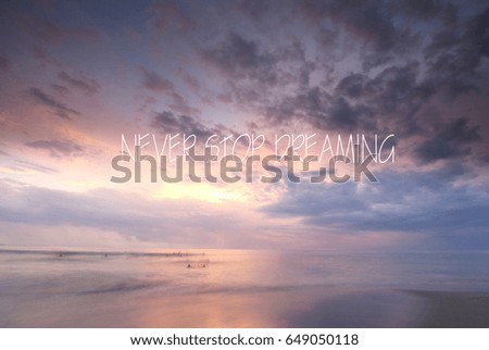 Blurry cloudy sunset with inspirational quote-  Never stop dreaming.