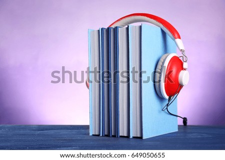 Headphones and books on table. Concept of audiobook
