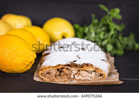 Strudel, pie with lemon on a dark background