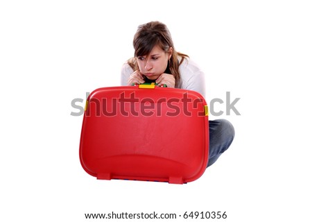 Travel concept: young bored woman with suitcase seated on the floor. Isolated on white
