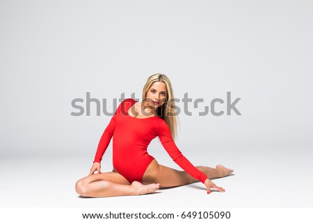 Young woman doing art gymnastic isolated on white background