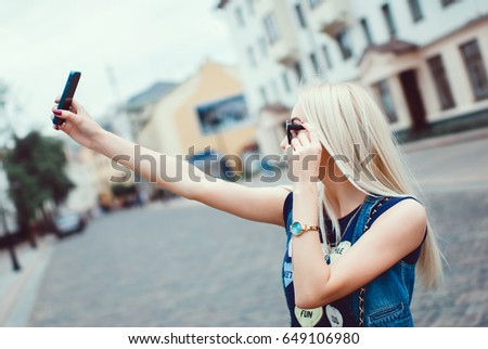 Young woman make selfie, posing in the street, outdoor portrait, hipster style, cute, like, photo, happy face, sisters, together, happy face, close up fashion model, woman using smartphone, sunglasses