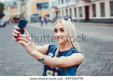young pretty woman posing in the street with phone, outdoor portrait, hipster girls, sisters, chic, tablet, internet, using smartphone, close-up fashion model, post in instagram, facebook