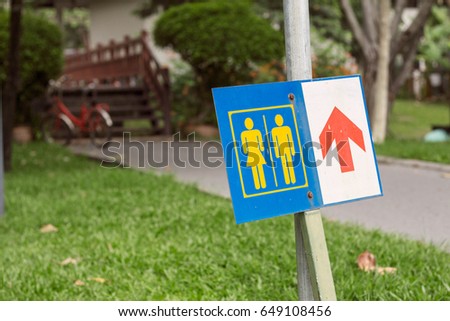 signs to male and female toilets in the park.