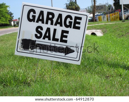 an image of garage sale sign on green grass