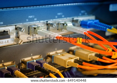 Fiber optic plug connect to fiber router high speed in technology data center room. Close up and selective focus