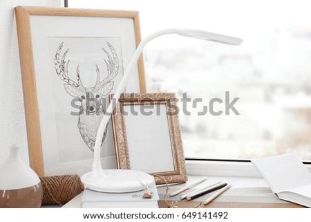 Creative workplace on windowsill in modern room