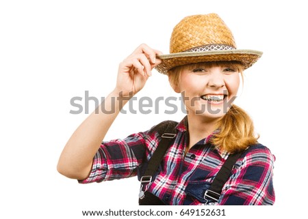 Gardening concept. Smiling attractive woman in pink check shirt and sun straw hat. Isolated background