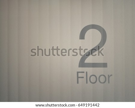 Second floor sign with light background