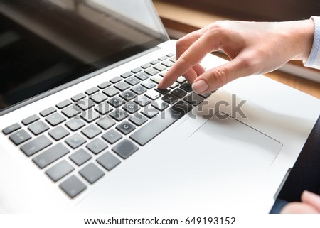 Closeup of hand using computer keyboard. Closeup of businesswoman hand using computer laptop keyboard 