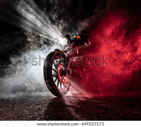 High power motorcycle chopper at night. Smoke on background.