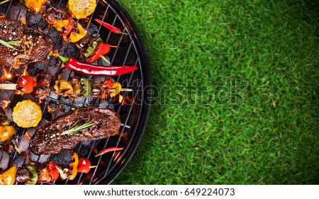 Barbecue garden grill with beef steaks, close-up. Royalty-Free Stock Photo #649224073