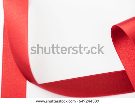 Abstract shapes background of red fabric ribbon on white background. Copy space. 