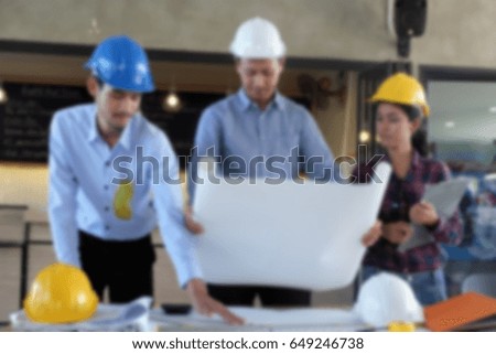 Blurred picture  of architect  businessman are planning  meeting to work , construction engineer looking  blueprint on table , team of professional engineers working with blueprints