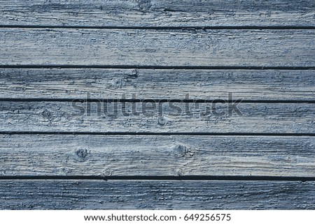 Blue peeling paint wooden desks background.