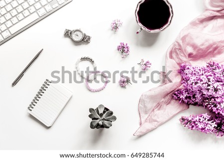 Work desk with lilac flowers in home office on white background top view space for text