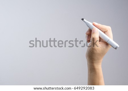 Hand holding gradient level adjustment permanent marker on white background