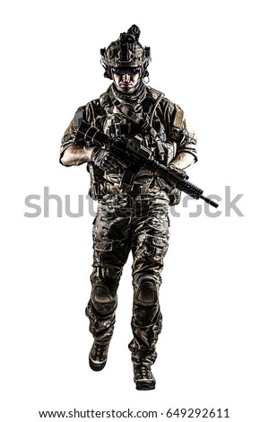 US Army rangers in combat uniforms with his shirt sleeves rolled up, in helmet, eyewear and night vision goggles moving walking towards camera. Studio shot, white background, dark contrast