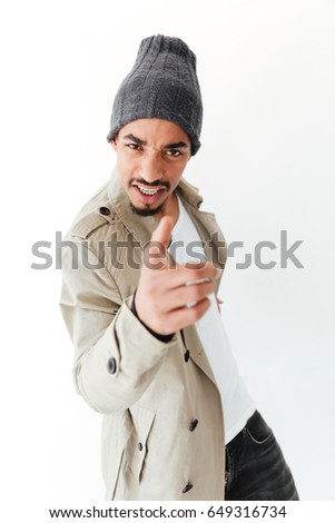 Picture of handsome young african man isolated over white background. Looking at camera pointing.