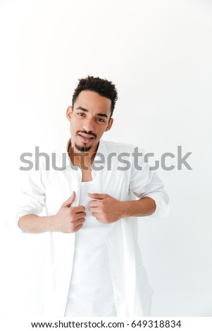 Picture of serious young african man isolated over white background. Looking at camera.
