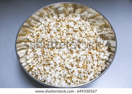 Popcorn in metal circle bowl.