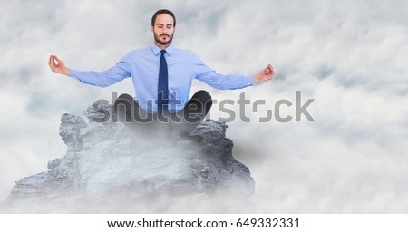 Digital composite of Business man meditating on mountain peak in the clouds