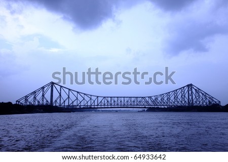 Long view of Howrah bridge in the evening light. Royalty-Free Stock Photo #64933642