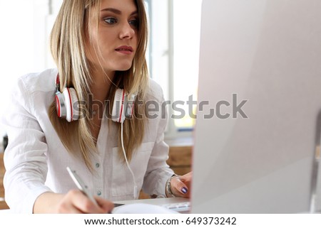 Beautiful woman making notes with silver pen while working on computer pc closeup. Management training course, leader ambition, modern remote school, self development and perfection concept