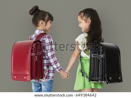 Girl and her friend are going to school