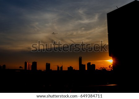 Buildings and structures are black shadows caused by falling sunlight and light under.Silhouette image