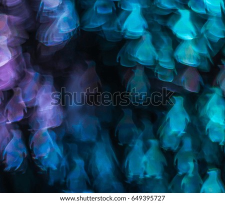Blurry light in the shape of a penguin, different colors of lights, abstraction, background, animal