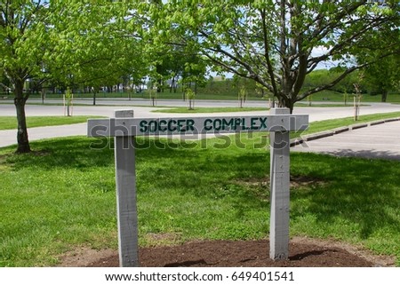 The wood soccer complex sign in the park.