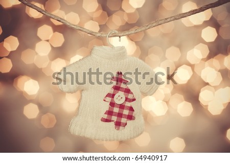 Colorful hanging Christmas ornament of shirt; on gold  background