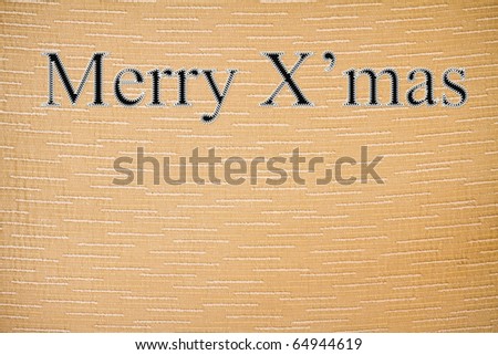 Christmas letters embroidered on the fabric surface.