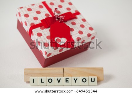 Conceptual image of gift and blocks displaying I love you message