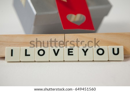 Conceptual image of gift and blocks displaying I love you message