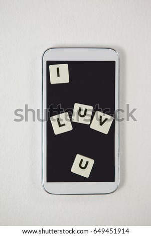 Conceptual image of mobile phone with blocks displaying I love you message