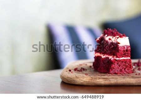 Red velvet cake was chipped on wooden plate
