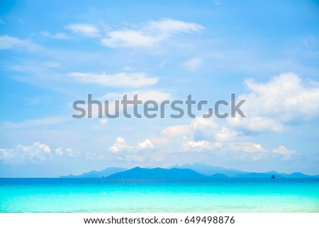 Beautiful white clouds on blue sky over calm sea with sunlight reflection, Tranquil sea harmony of calm water surface. Sunny sky and calm blue ocean. Vibrant sea with clouds on horizon