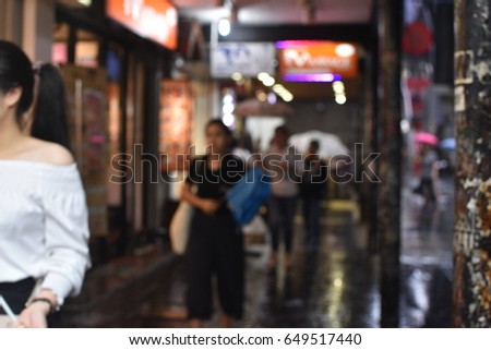people walking with umbrellas blur background , bangkok thailand 