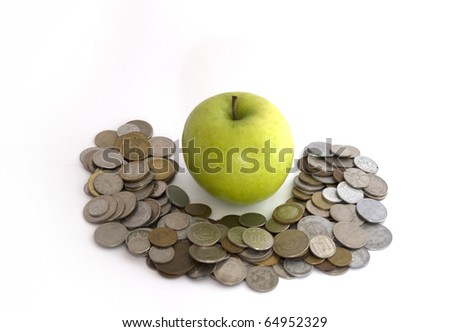 Green apple on the heap of coins