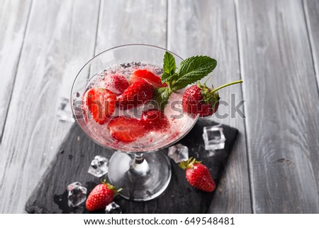 Strawberry margarita cocktail on a wooden background
