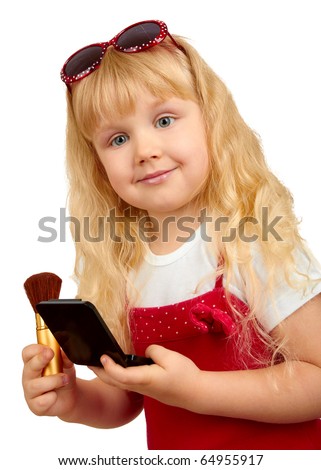 Little blonde girl is playing with make-up over white background
