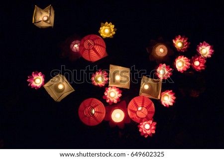 Floating paper lanterns on the water at night in the park