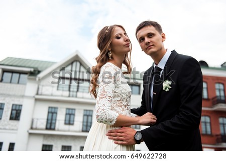 gorgeous happy wedding couple walking and kissing in the old city of Minsk, Belarus