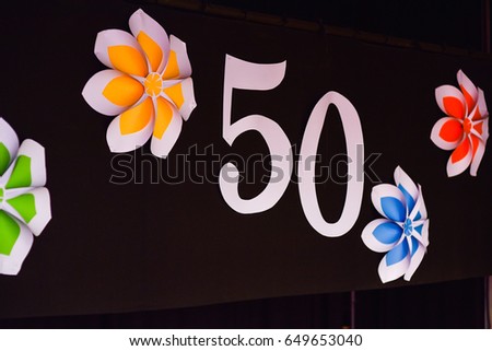 Number of 50 on the dark wall with colorful flowers