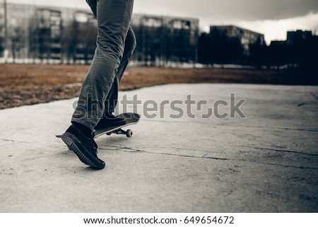 Man is going to skateboarding on the road, people, sport and skateboarding. concept of active recreation. Monochrome and high contrast.