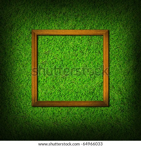 wood frame on green grass field background