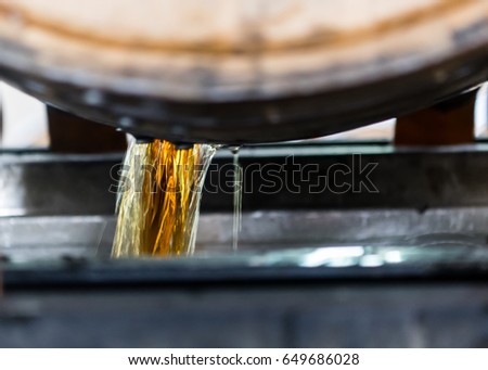 Bourbon Emptying from Freshly Opened Barrel along production line Royalty-Free Stock Photo #649686028